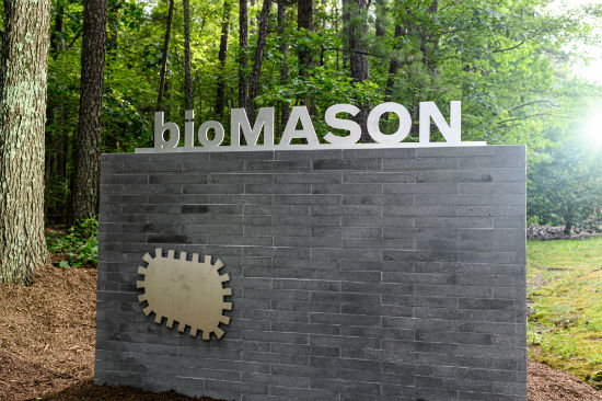 bioMASON logo on wall made of its biocement bricks