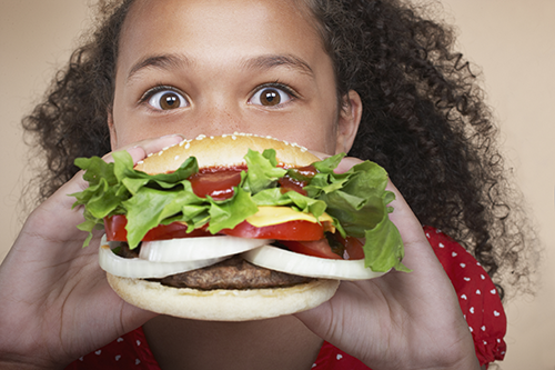 iStock photo of girl eating burger